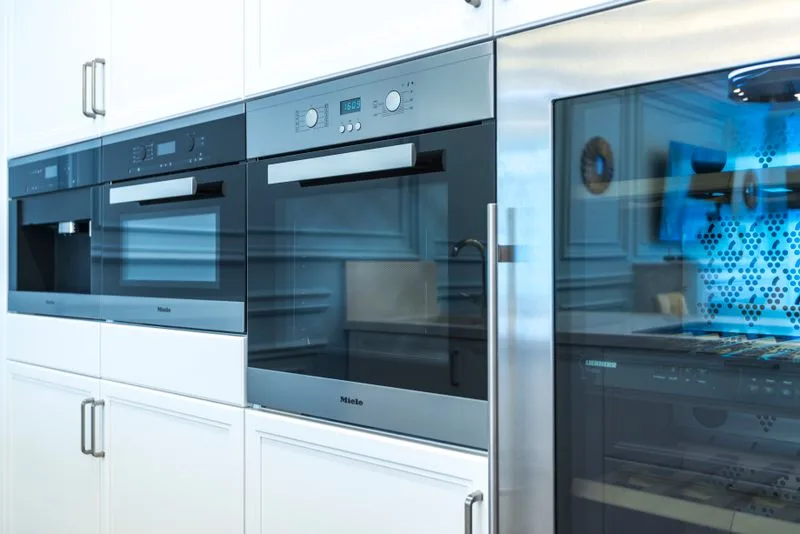 Built-in electric oven with modern cabinetry in luxury kitchen